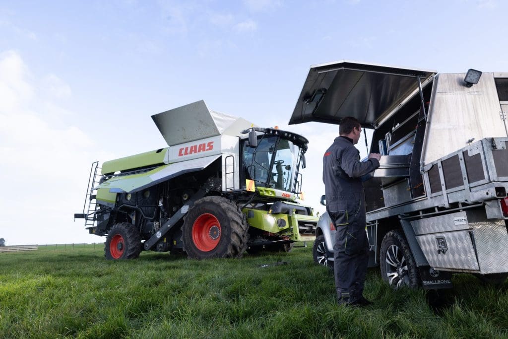 image of LEXION in a paddock getting serviced