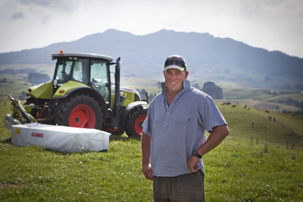 image of a customer in front of his tractor