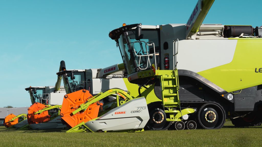 image of three used claas lexion combine harvesters with booms out